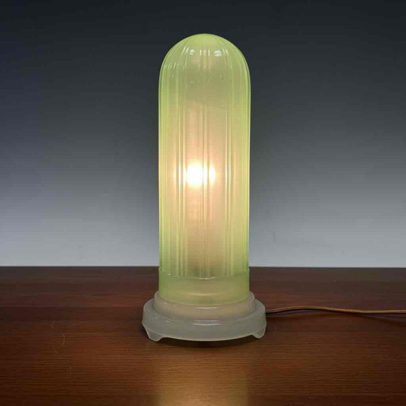 Art Deco Green Glass Skyscraper Lamp: Unique small tableside Art Deco green glass lamp. All original Torpedo or skyscraper style lamp. 5 Tier opalescent base with slip-over green glass shade. Excellent condition with no chips, cracks or r