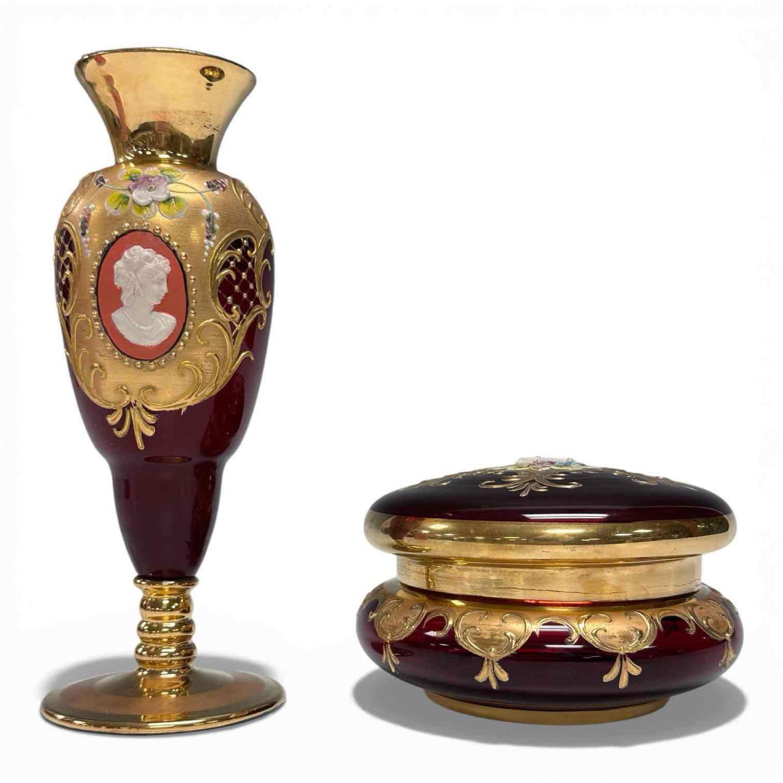 Hand Painted Ruby Murano Glass Gold Trimmed Vase and Lidded Compact Jar: Handcrafted Venice, Italy, using the traditional "Tre Fuochi" (three firings) technique. Decorated with gold and enamel details cameo and floral design on vase with a floral center medallion on the li