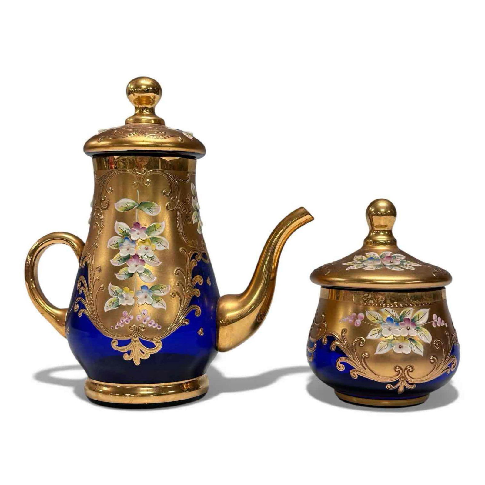 Murano Cobalt Blue 24kt gold Tea Set: Very intricate teapot and lidded sugar bowl. Cobalt blue Murano glass adorned with detailed gold detailing and vibrant enameled flowers. All gold trim appears to be in great shape still, with no loss.