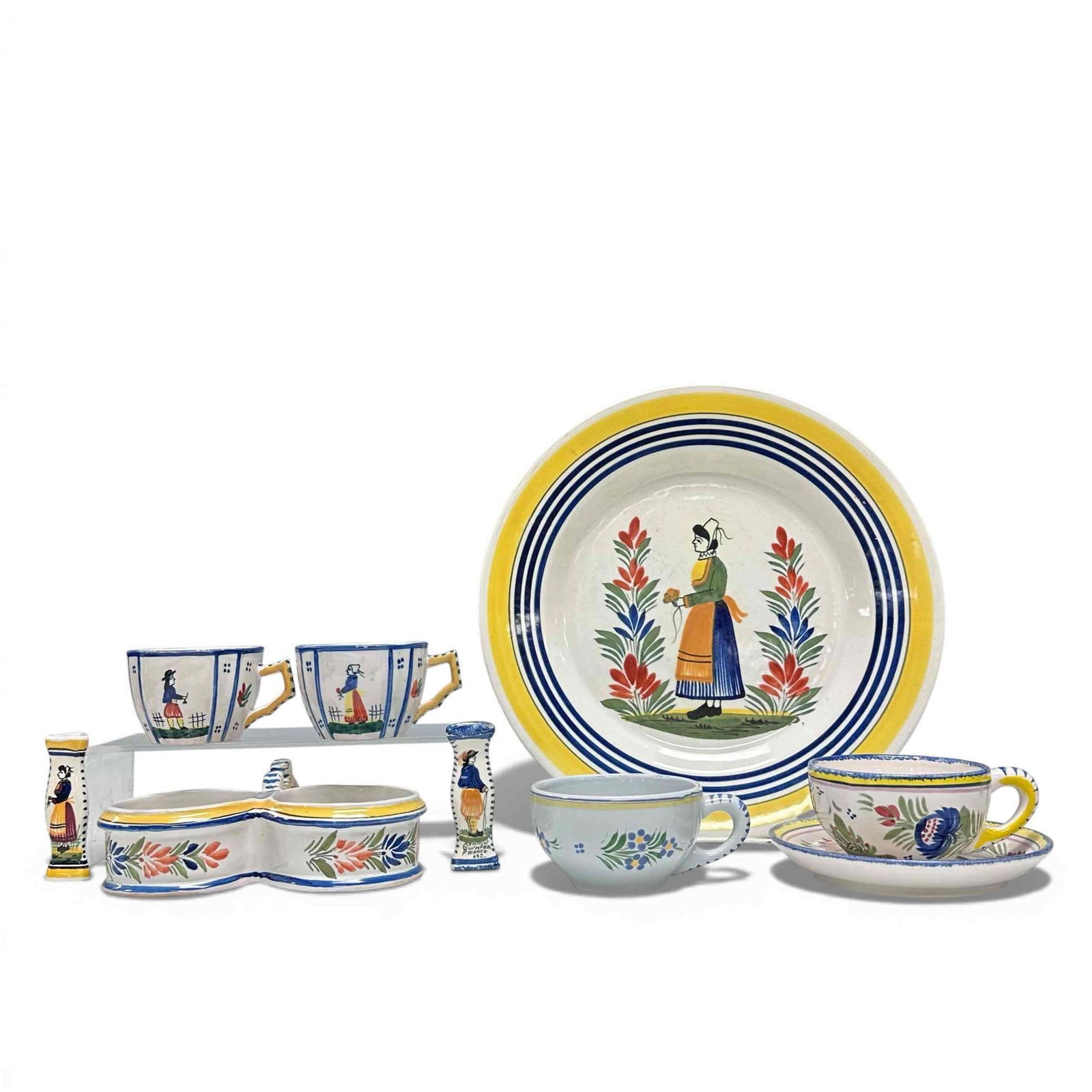 Collection of Hand-Painted Henriot Quimper Faience Pottery: Collection of miscellaneous Quimper pottery. Large serving platter, 4 coffee cups(small minor shipping on some), knife holders, double salt/butter tub (small minor chipping), and saucer. See photos fo
