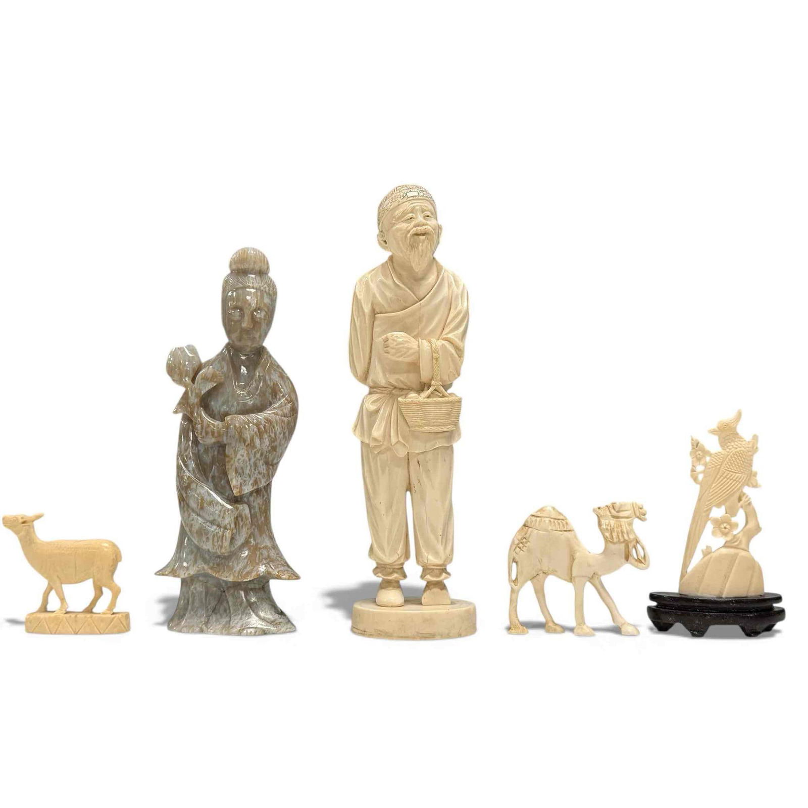 Carved Soapstone Guanyin with Carved Figures (5): Carved soapstone statue of Guanyin "Goddess of Mercy and Compassion" holding a lotus 8.25" tall, carved elder man with basket of eggs while hiding his pipe behind back appears to be made of faux ivory