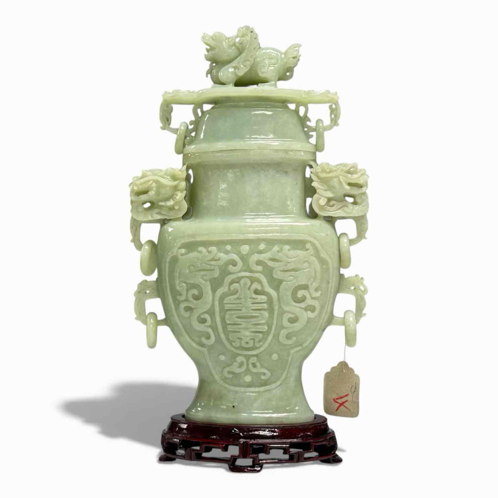 Chinese Carved Serpentine Jade Vase With Cover: Carve jade/jadeite light green lidded urn style vase depiction serpent and dragon throughout with six free moving ring, three on either side. Seated on a form fitted footed wooden base. Has original s