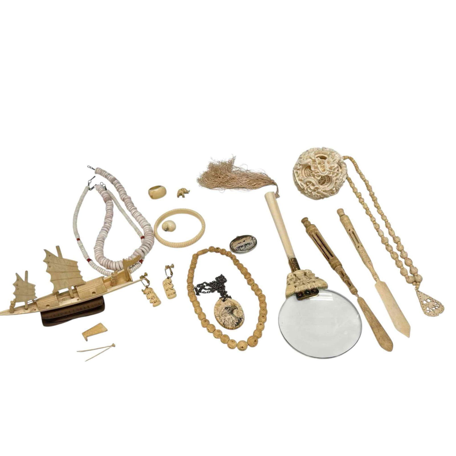 Asian Bone Carvings Jewelry Puzzles and Tools Collection: Chinese dragon devil ball puzzle 3", carved Stanhope dip pen, carved magnifying glass, beaded necklaces, letter opener, pendants, carved boat and more. In age appropriate condition, see photos.