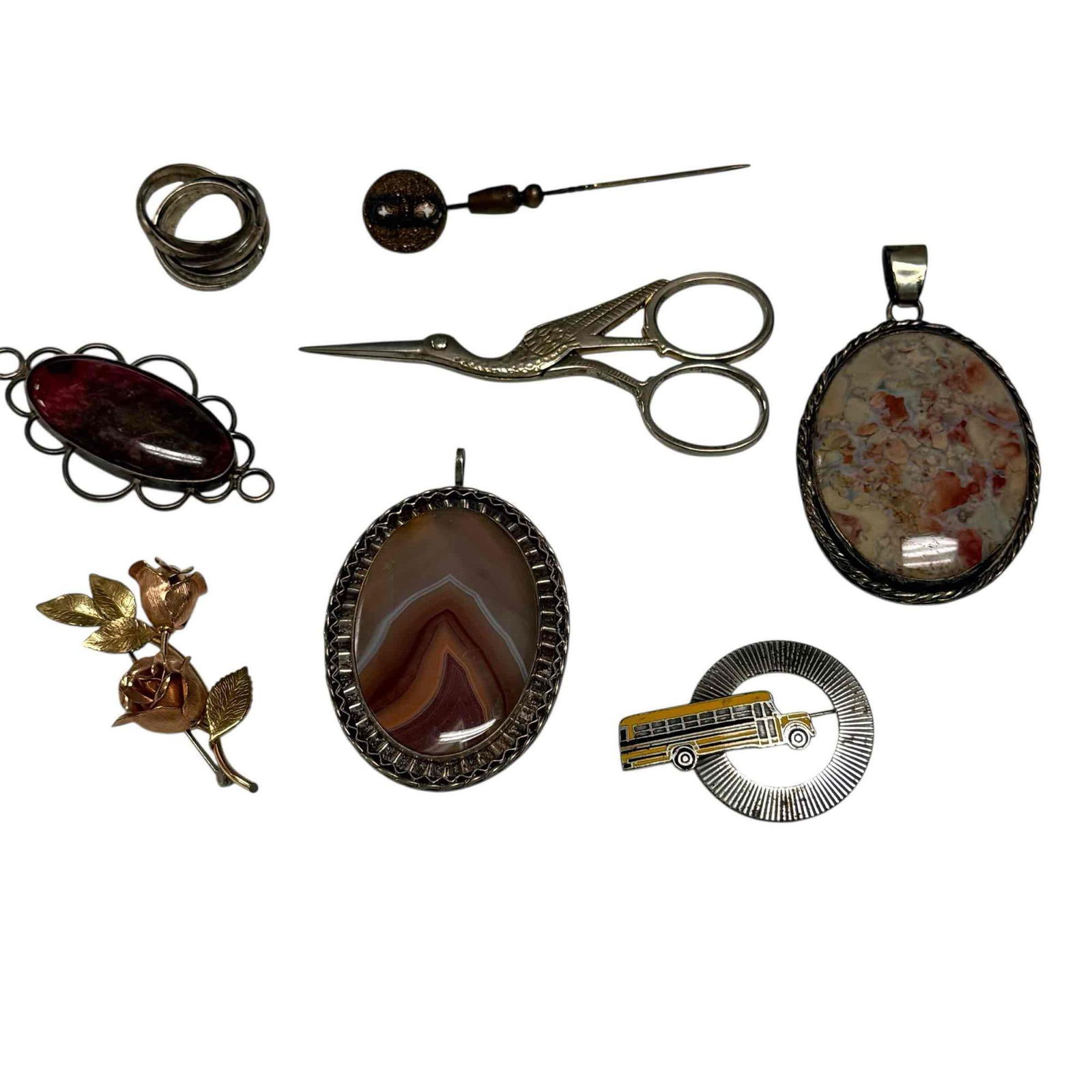Sterling Pendants Pins and Stork Embroidery Scissors (8): Includes; three hard stone sterling silver pendants 2.25" tall, stork scissors 3.5" long, two tone gold rose brooch, bronze pi, school bus pin and interlocking rings. In good condition, see photos.