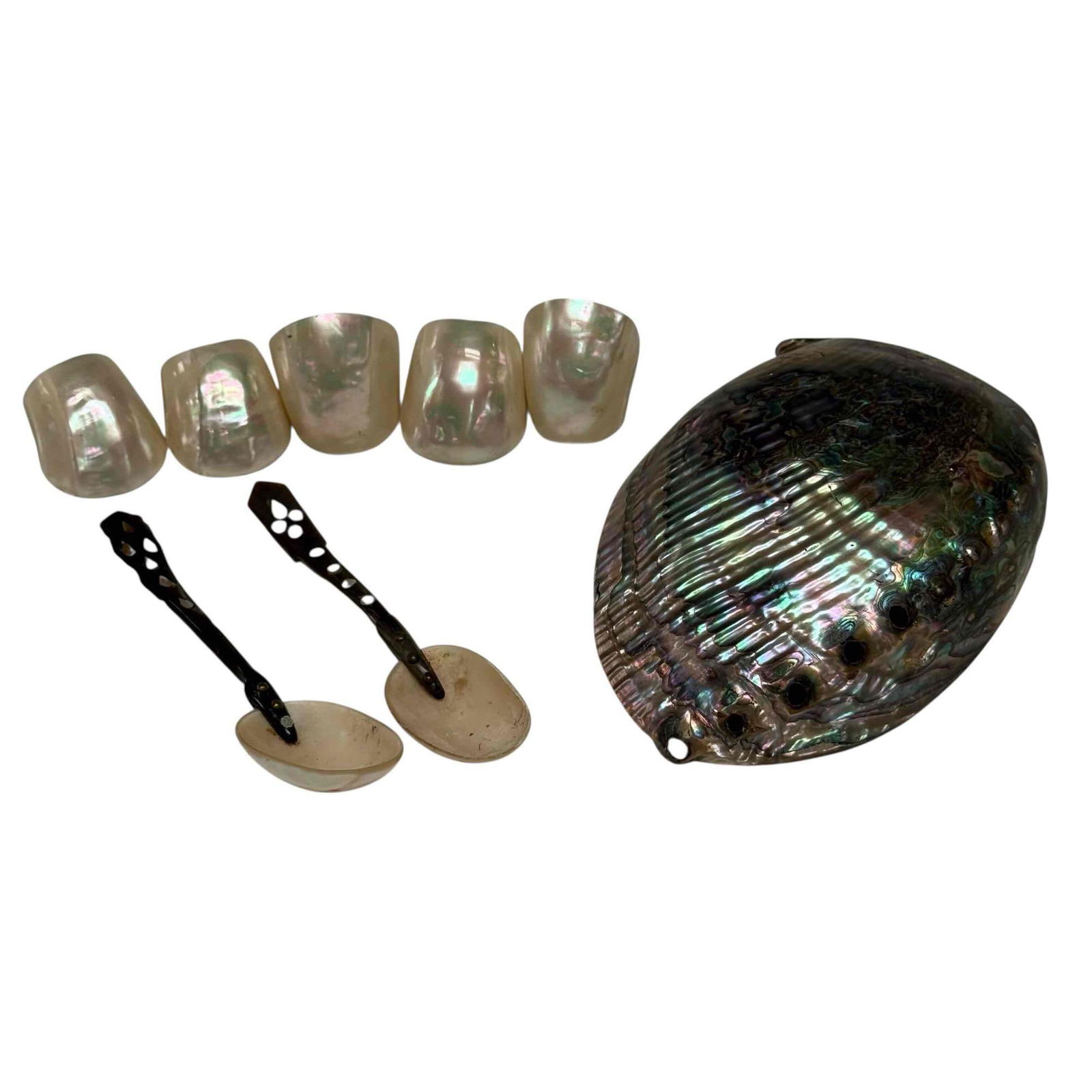 Polished Paua Abalone Iridescent Shell Spoons and Napkin Rings (8): Mother of pearl inlaid shell caviar spoons 6" long, large polished Paua Abalone shell 6.75" long and iridescent abalone shell napkin rings. In good age appropriate condition, see photos.