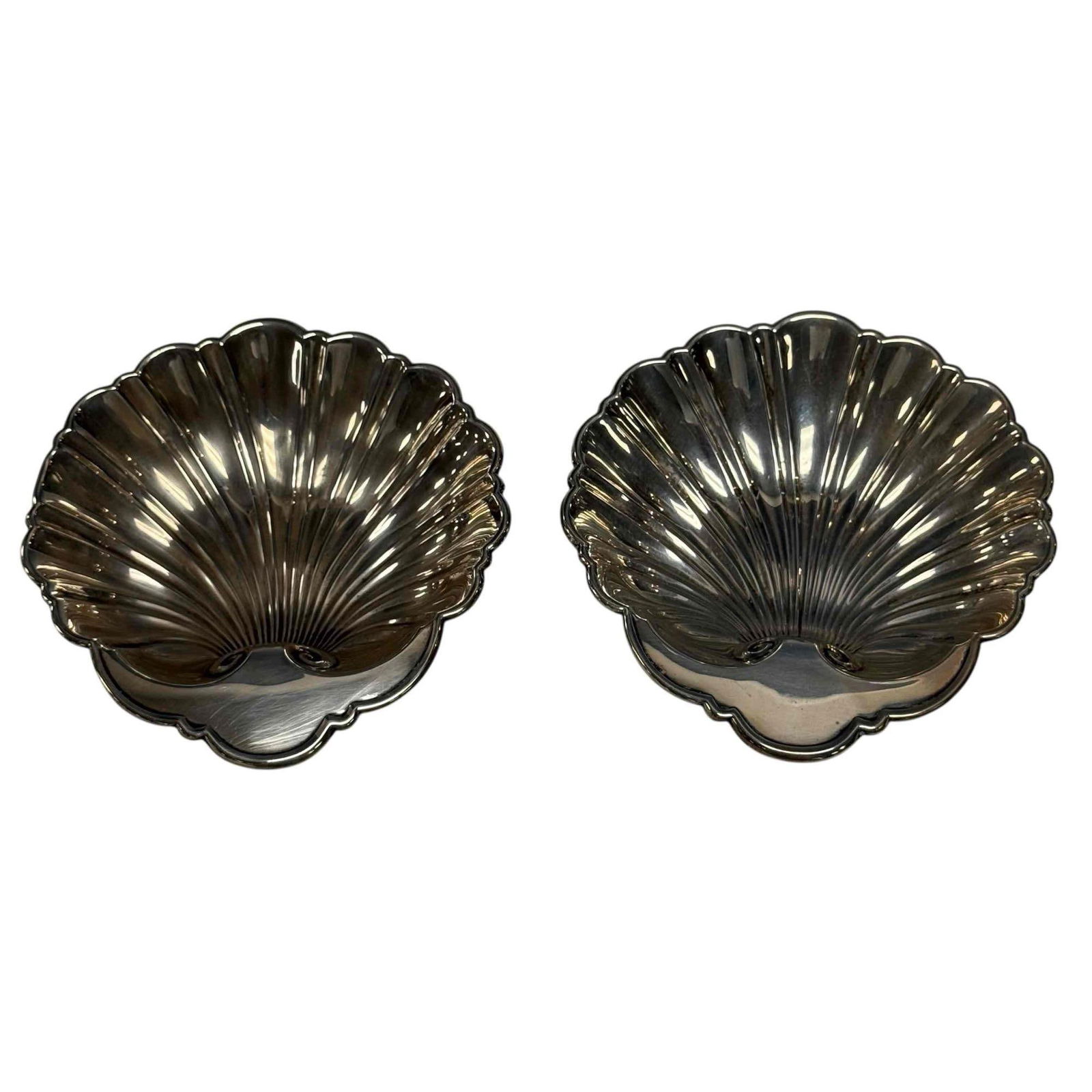 Gorham Sterling Silver Shell Form Nut Dishes (2) 146 Grams: Pair of Gorham sterling silver no. 445 shell form nut dishes. Measuring 1" tall by 5" long, weighting 146 grams. In good age appropriate condition, see photos.