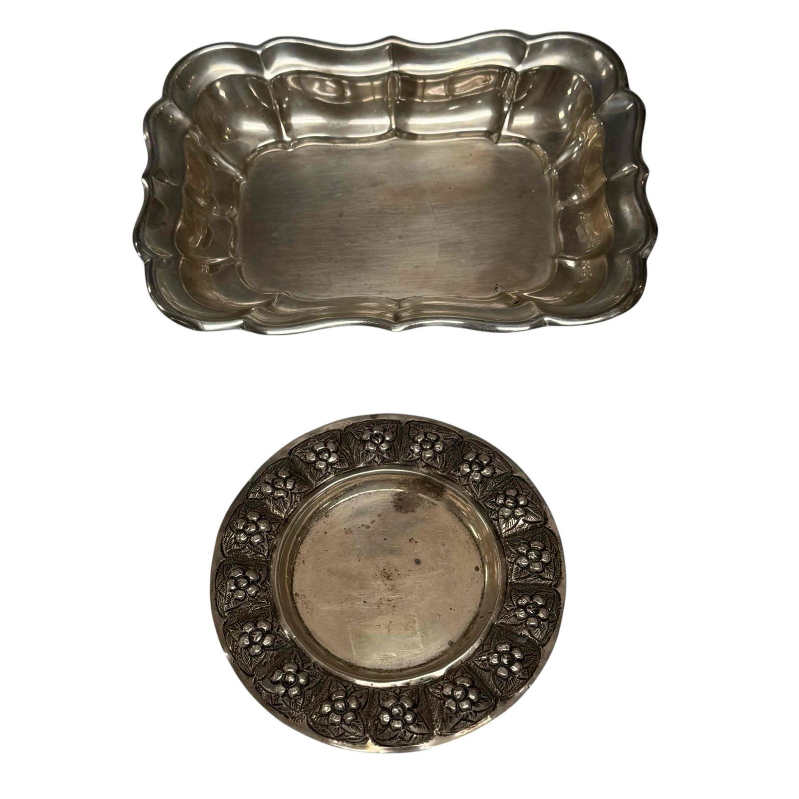 Sterling Silver Nut and Candy Dishes (2) 202 Grams: Reed and Barton sterling silver "Windsor" pattern nut or fruit tray 1" tall by 7" long weighting 126 grams and repousse flower pattern sterling silver nut dish 4.5" diameter weighting 76 grams. In goo