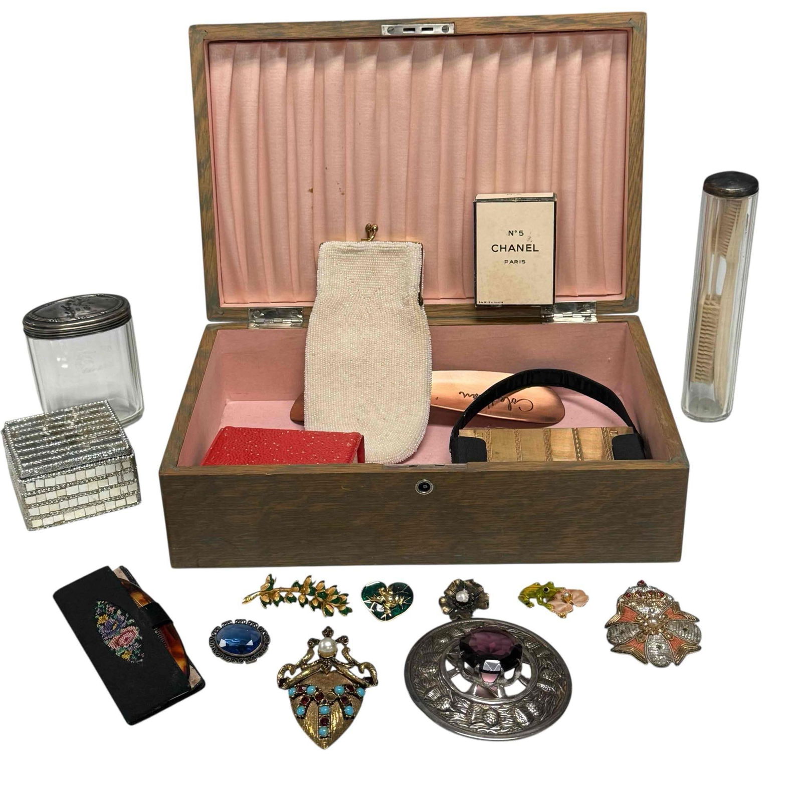Ladies Vintage Vanity & Jewelry Grouping: Includes; vintage Chanel No. 5 box, 2.75' tall, rhinestone brooches, frog and lily pad pins, antique glass vanity jars, beaded hand bag, Volupte gold tone compact purse and more inside wooden chest 3.