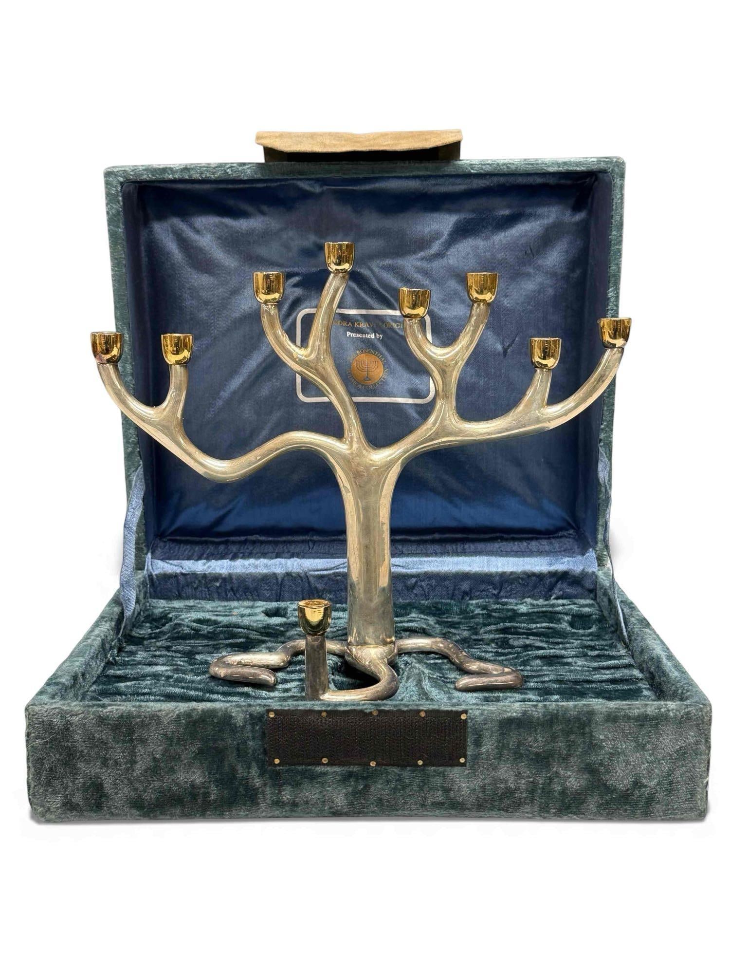 Judaica Rosenthal Menorah Tree of Life by Sandra Kravitz: Judaica Menorah Designed by Sandra Kravitz and Made by Rosenthal. In Original Fitted Blue Box. Fully Signed. Measuring approx. 8.75" tall by 11" wide. In good condition with some wax drippings, see ph