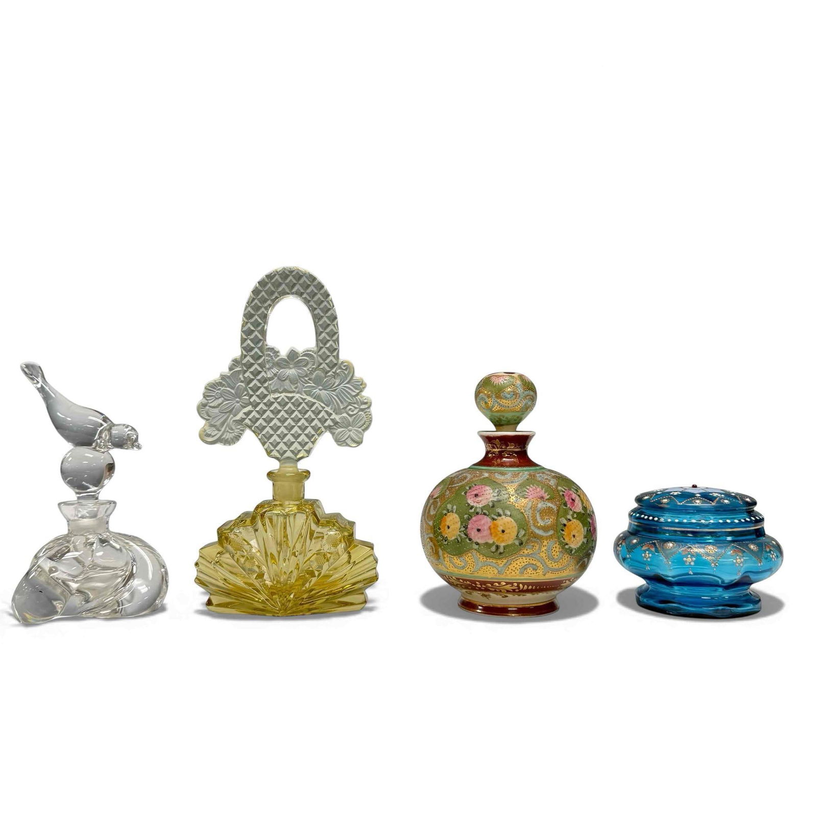 Ladies Perfume Bottles and Vanity Grouping (4): Including; Art Deco Czechoslovakia light amber sunburst perfume bottle with floral diamond pattern basket stopper 8.5" tall, swirl base perfume bottle with bird form stopper 6.25" tall with small chip