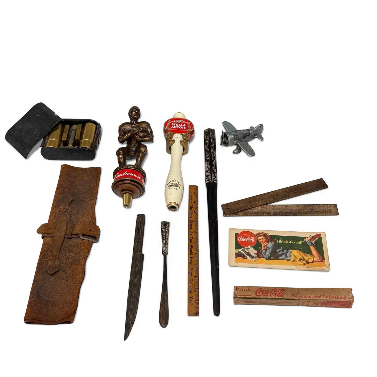 Budweiser, Coca-Cola, African Tribal and More eBay Lot: Great eBay collection lot. Budweiser Heisman Trophy beer tap handle, Stella Artois tap handle, Coca-Cola items, African tribal carved wood pieces, Gillette Brass Travelers shaving kit (cover detached)