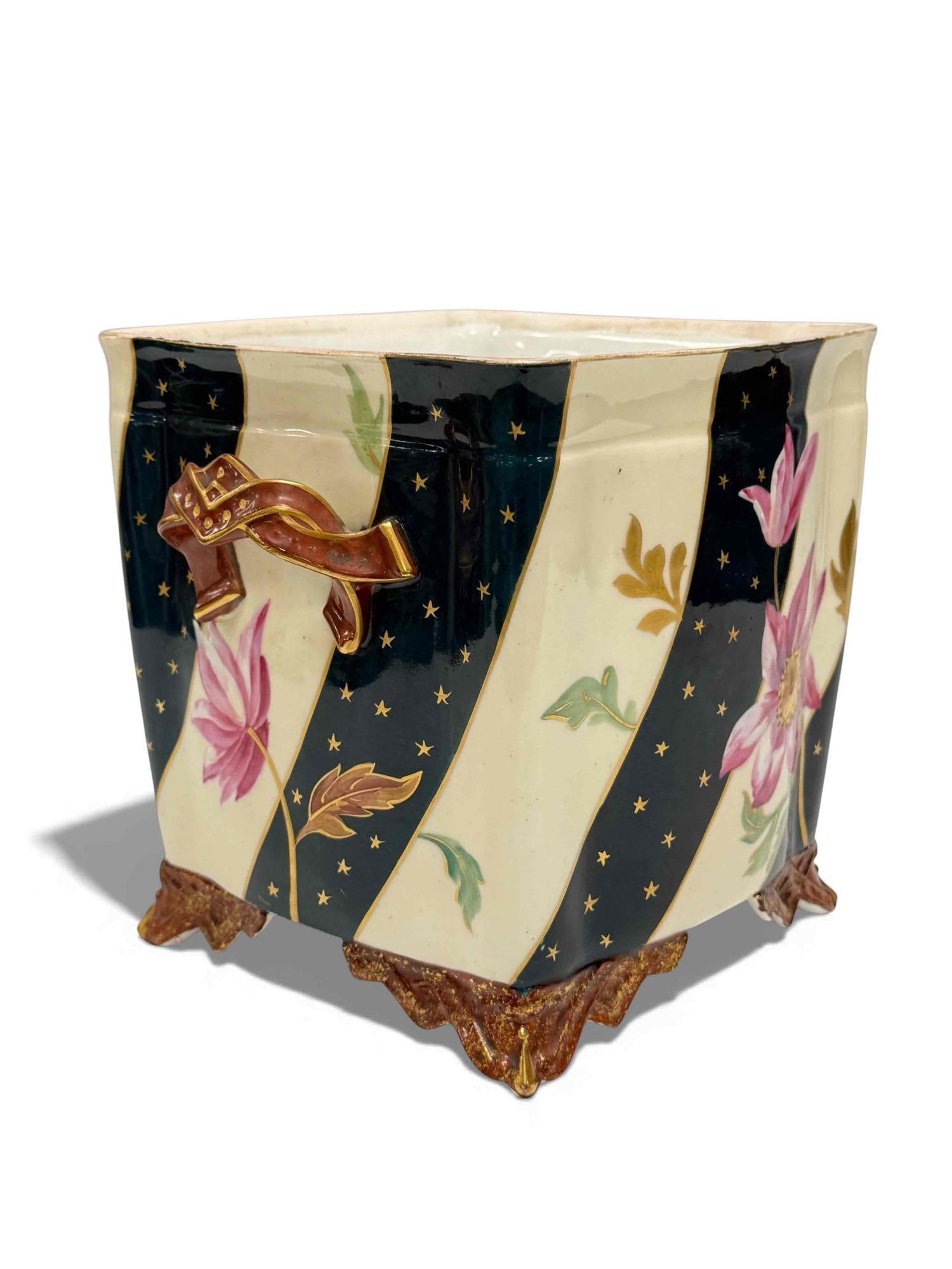 Leon Sazerat Limoges Hand Painted Jardiniere: Hand painted ceramic jardiniere. By Leon Sazerat Limoges France. Cream or white colored with gold trimmed blue bands and stars. Red/gold feet and handles, giving it a patriotic look. Also has hand pai