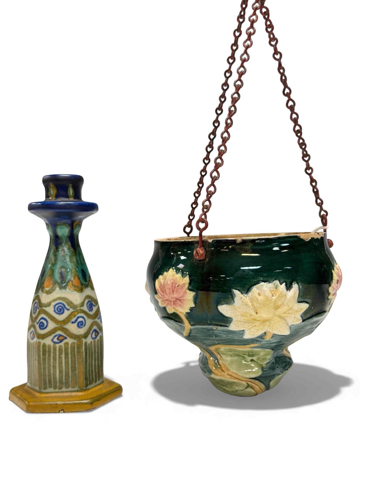 Gouda and Hanging Basket Porcelain Lot: Gouda porcelain 6" candlestick with paisley design, and a 5" x 5" porcelain hanging flower basket with hand-painted floral design. Some paint loss along the rim. See photos for condition details.