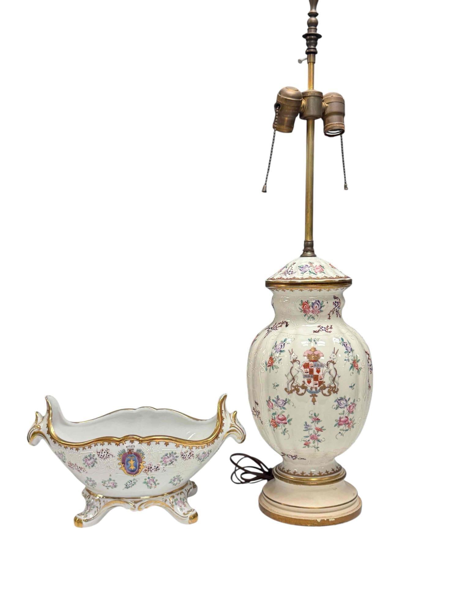 19th Century French Export Armorial Porcelain Vase/Urn Fitted Lamp with Footed Center Bowl: 19th century hand painted French Samson porcelain armorial lidded vase or urn converted to lamp. Depicting coat of arms flanked by two rampant goats reading "Trough" banner below. Having raised enamel