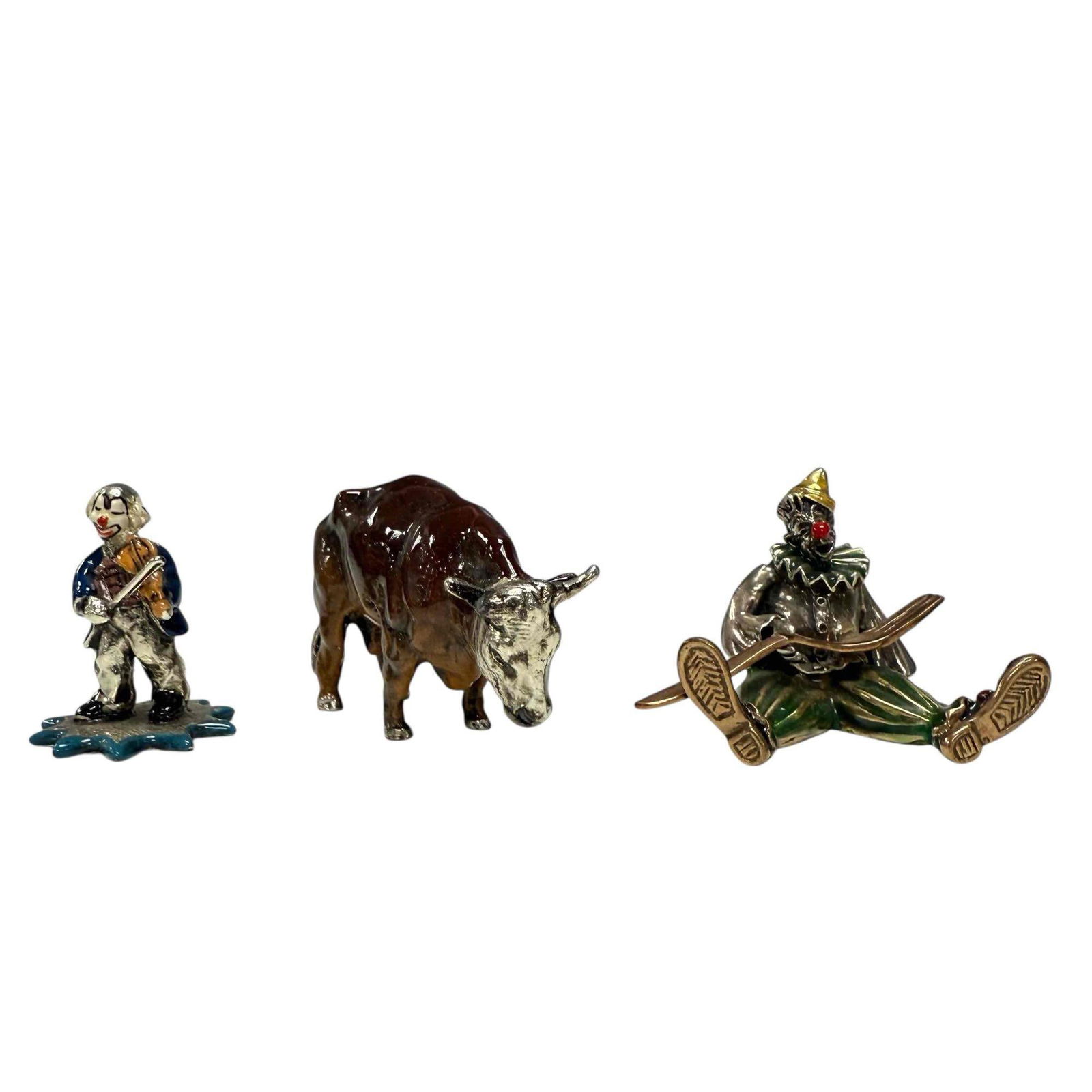 Two Miniature Enameled Italian Clown Figures and a Steer: Small figural group. Enameled metal and silver as shown. tallest measuring approx 1.5" x 1" x 1". See photos