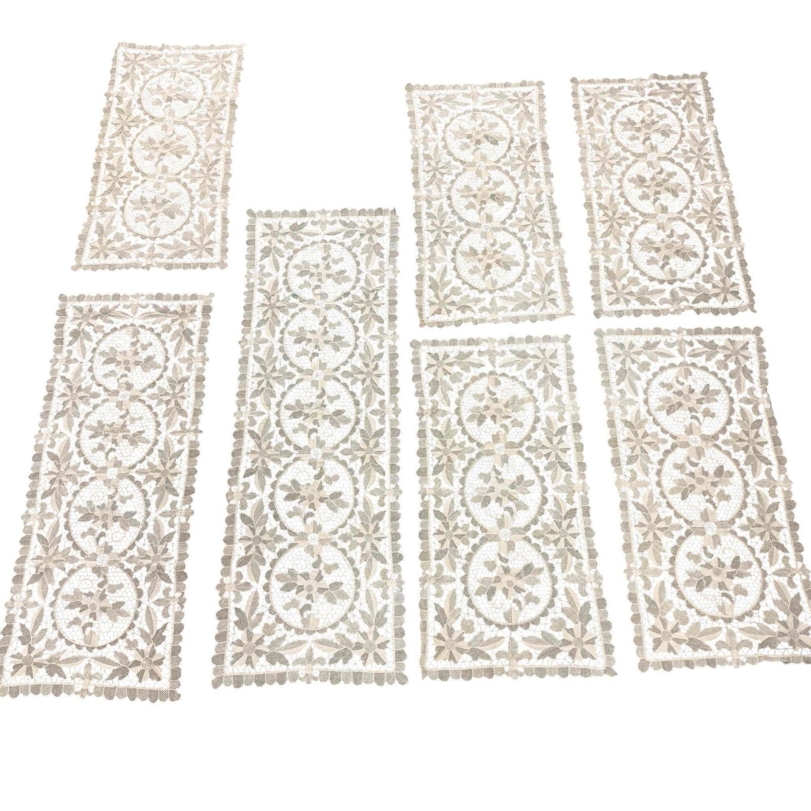 (7) Fine European Hand Made Lace Table Runners: Very beautiful beige, vintage hand made lace table settings set. Includes three sizes: (5) 16" x 32", (1) 16" x 40", (1) 16" x 49" All pieces are in very good overall condition.