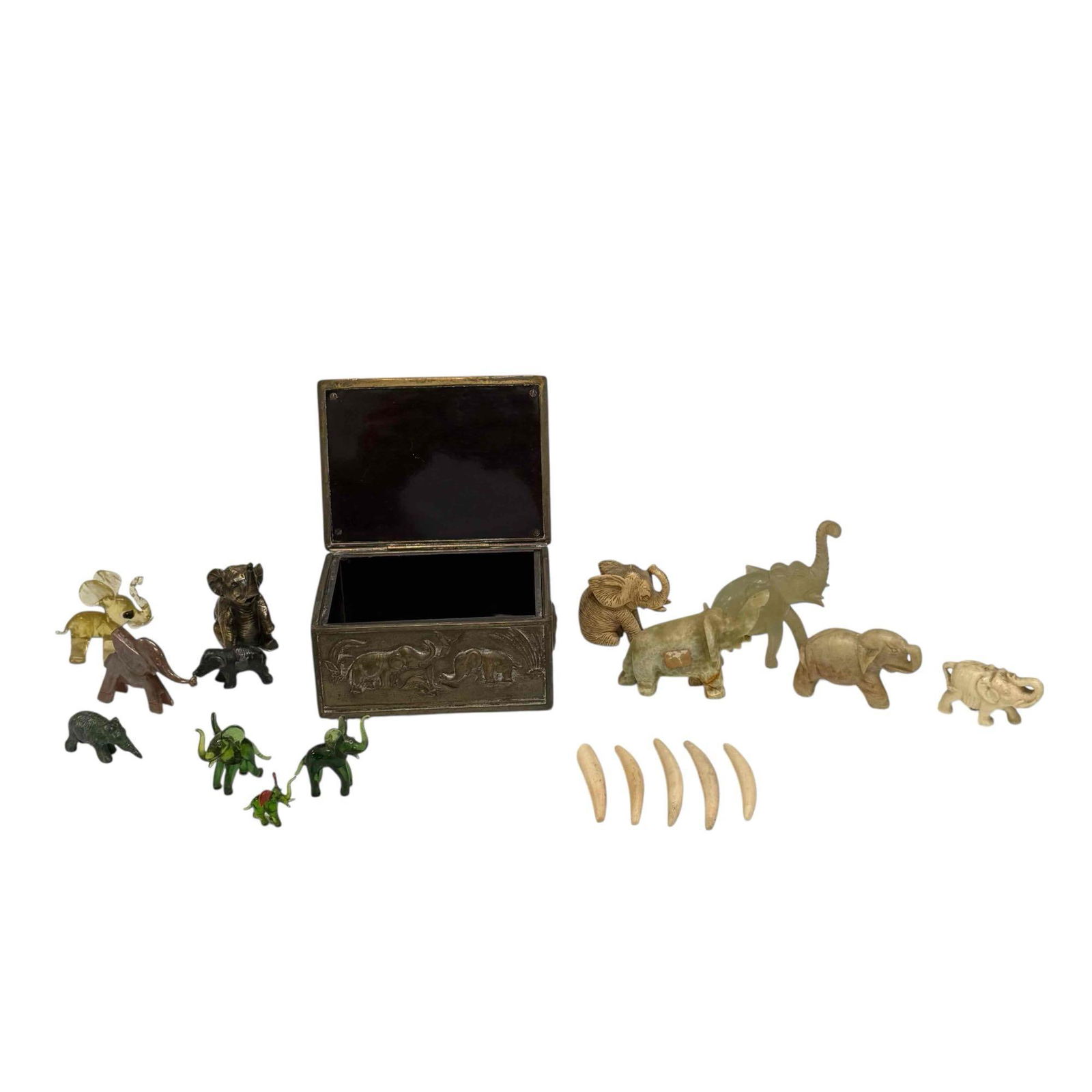 Elephant Figurine and Embossed Bronze Elephant Box: Carved jade and stone, blown glass resin, brass and cast iron cold painted elephant figurines measuring from .5" to 3" tall and Jennings Brothers raised relief bronze elephant casket box 2.25" tall