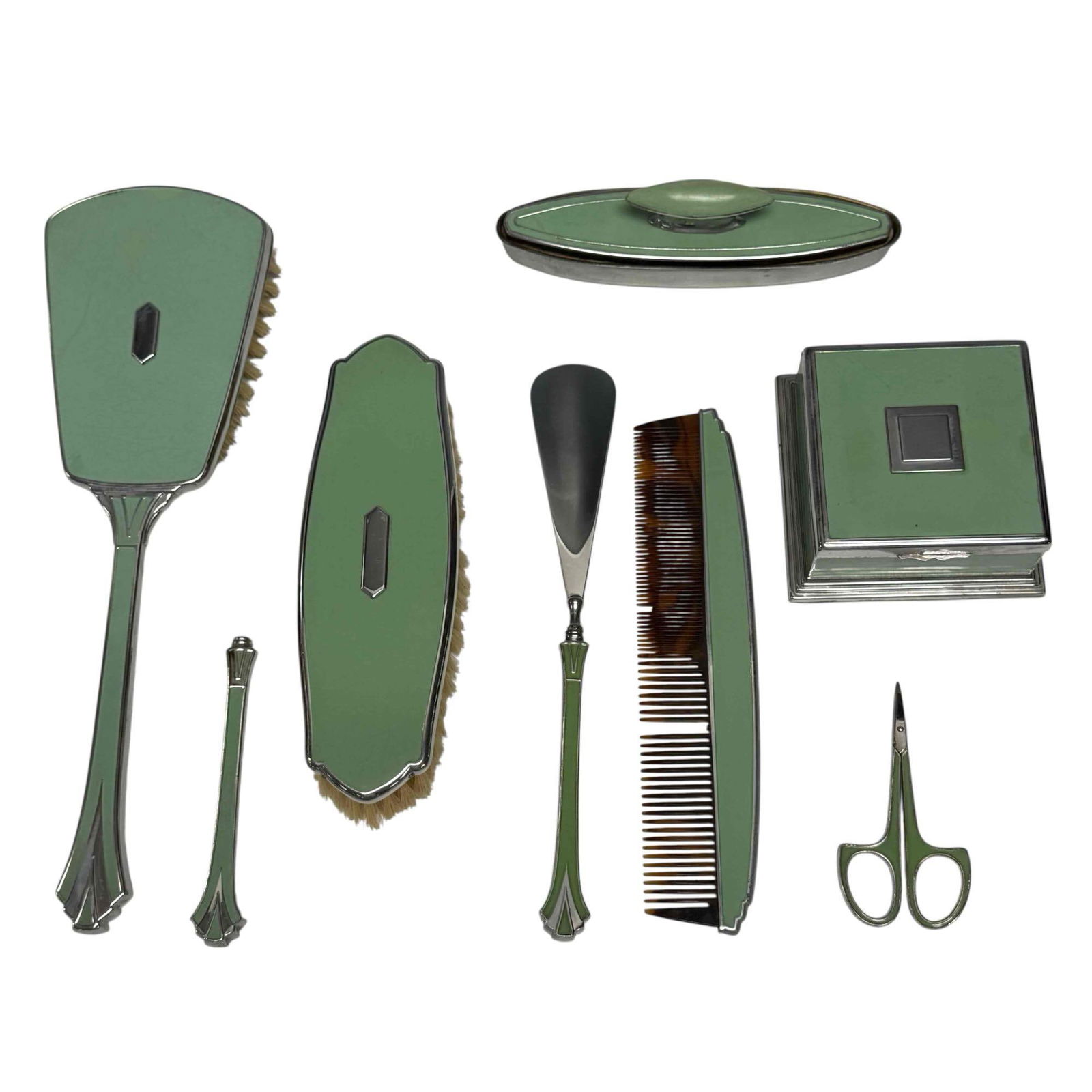Art Deco Green and Chrome 7 Piece Vanity Set: 1920's-30's green and chrome art deco dresser top vanity set including; powder box 3.75" wide, brush 11.25" long, comb 8" long, shoe horn 9" long, lint brush 7.25" long, nail buffer 6.25" long and ext