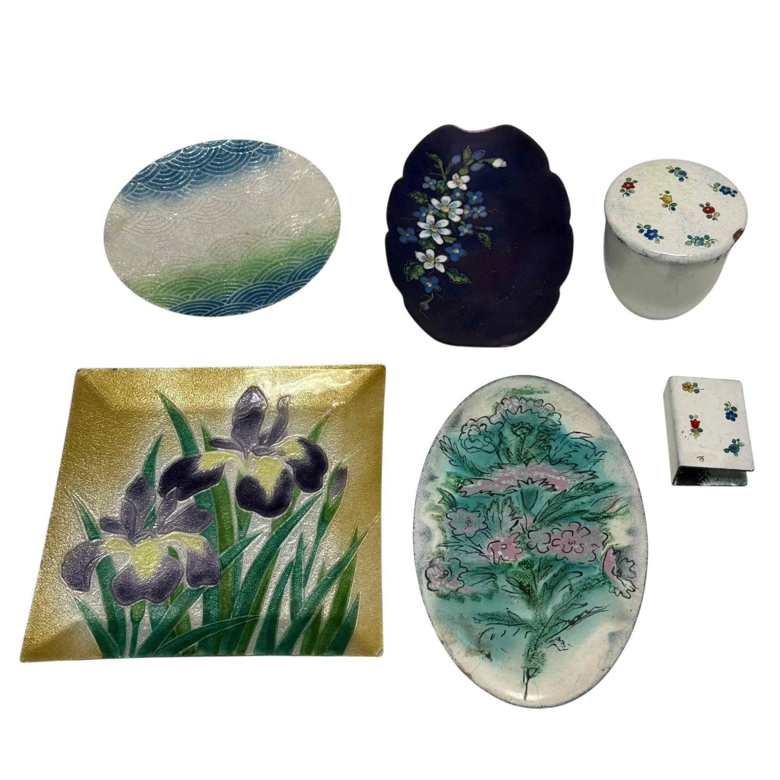 Enamel Over Copper Dishes Letter Holder and Lidded Jar (6): Six piece enamel over copper including; Japanese Saikosha purple iris plate 7" wide, oval floral tray 8" long, crescent pattern plate 5.75" wide, purple scalloped oval tray 7" long and matching white
