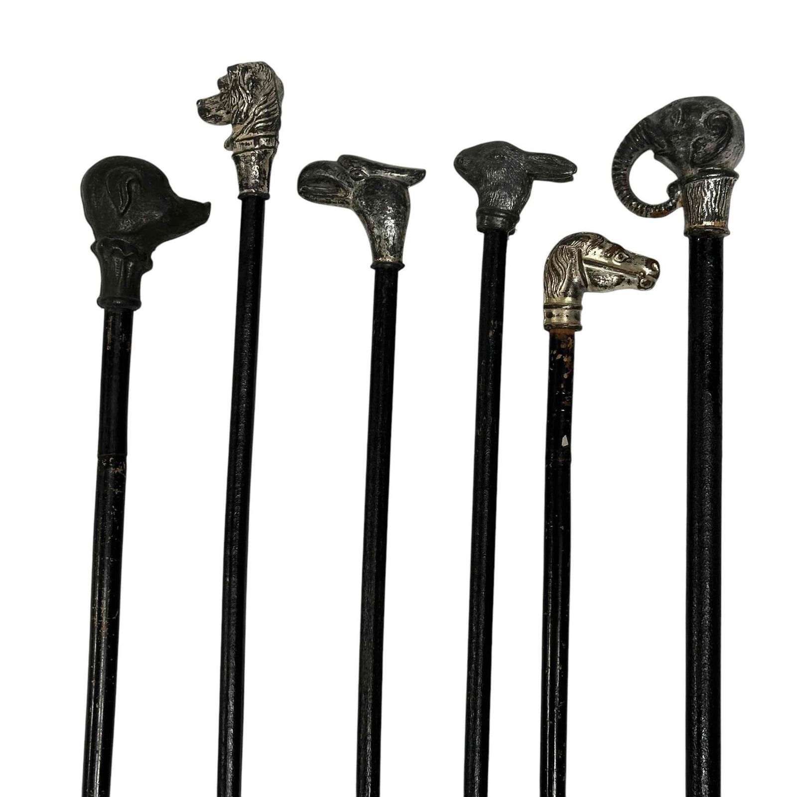 Six (6) Carnival / Circus Canes w/Cast Metal Tops: Six carnival or circus canes with cast metal tops. The tops depict different animals like elephants, rabbits, horses or other animals. Tops feel secure. Some wear and loss to paint along the canes.