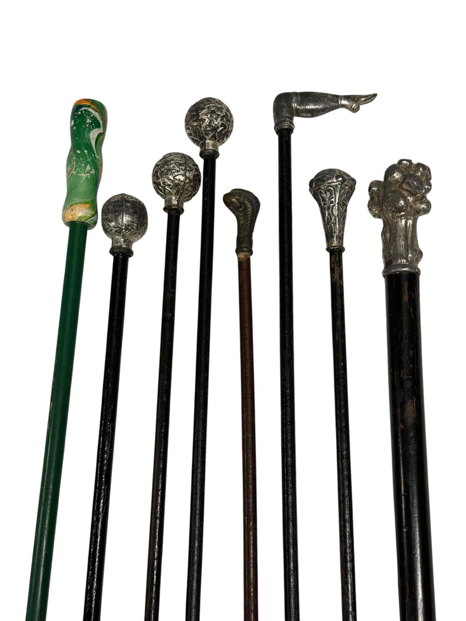 Late 19th Early 20th Century Canes Walking Sticks (8): Collection of eight vintage walking sticks/canes with unique knobs including Burlesque lady dancer leg, baseball, turkey claw holding acorn, art nouveau and brutalist form. Measuring approx. 34" to 36