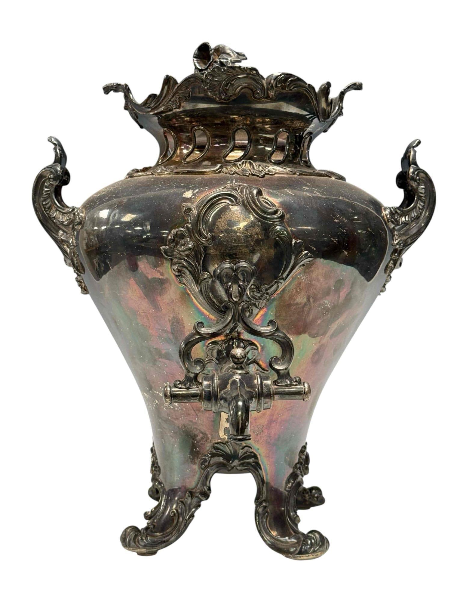 19th Century Art Nouveau Silver Plated Samovar: Complete with interior, floral finial cap, scroll feet and double handles. Measuring approx 17" h x 14" w x 12.5" d. Light use and wear consistent with age as shown, see photos