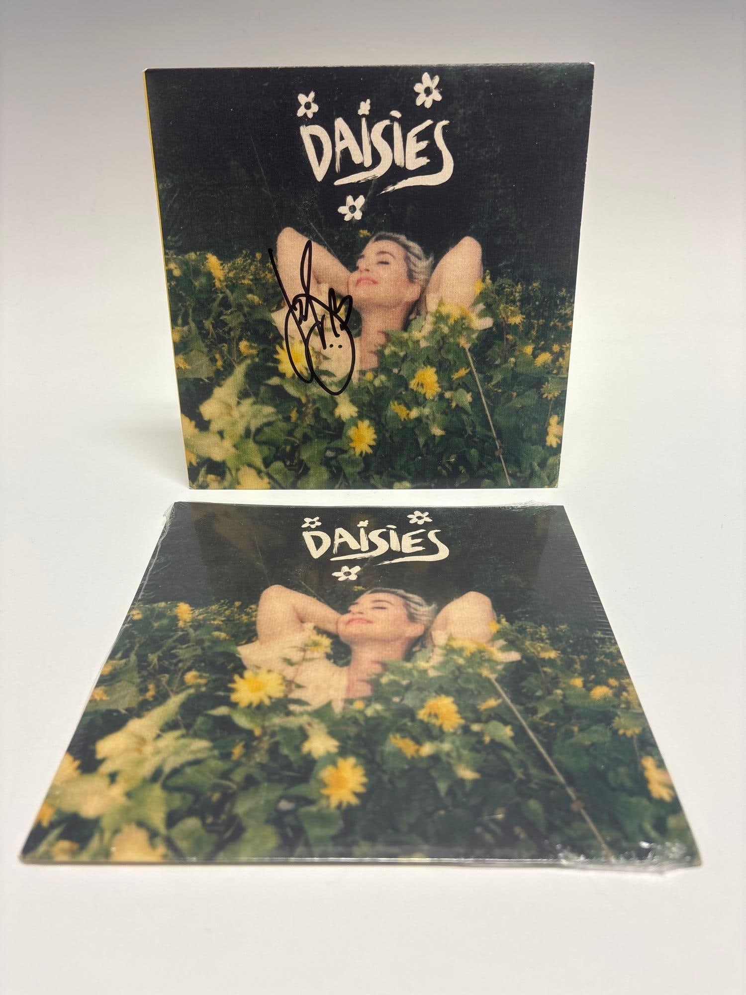 Katy Perry Autographed Daisies 7x7 Single Album + Unsigned Sealed: Single of the 2020 hit song. This lot includes a sealed, unsigned album and a unsealed cover(no record) signed on the cover in black marker. Autograph jumps out at you! Don't pass up this one! Easy to