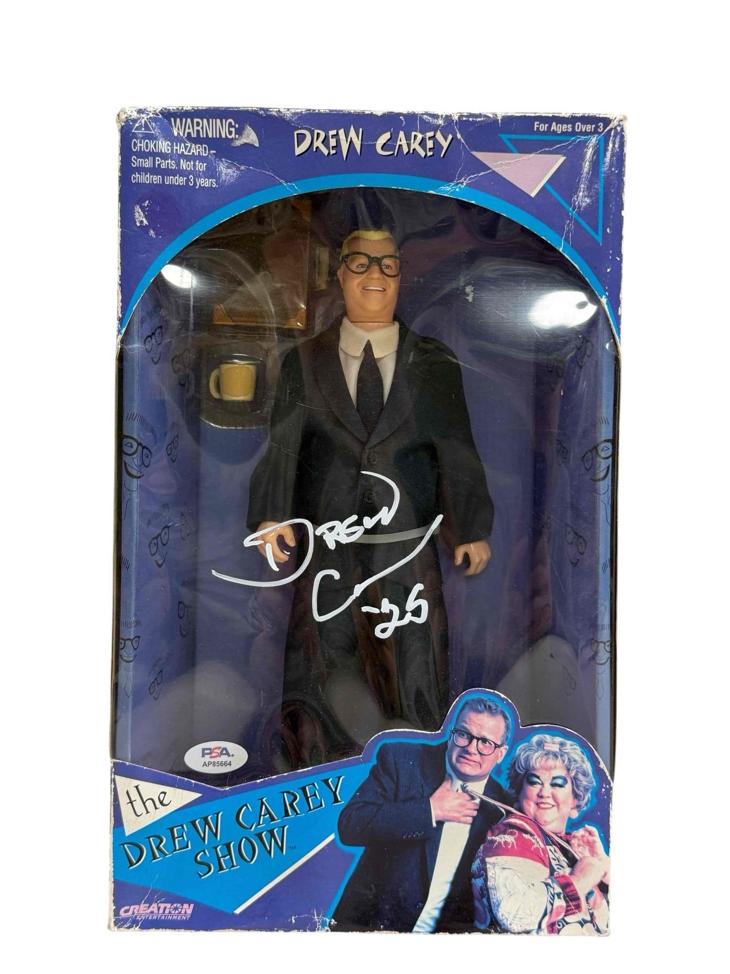 Drew Carey Doll 1998 Creation Autographed Box / Packaging PSA: The Drew Carey Show doll in original box. Carey autographed on the plastic window of the box. Large signature along with " '25" inscription. Box/packaging is in decent condition with some signs of age