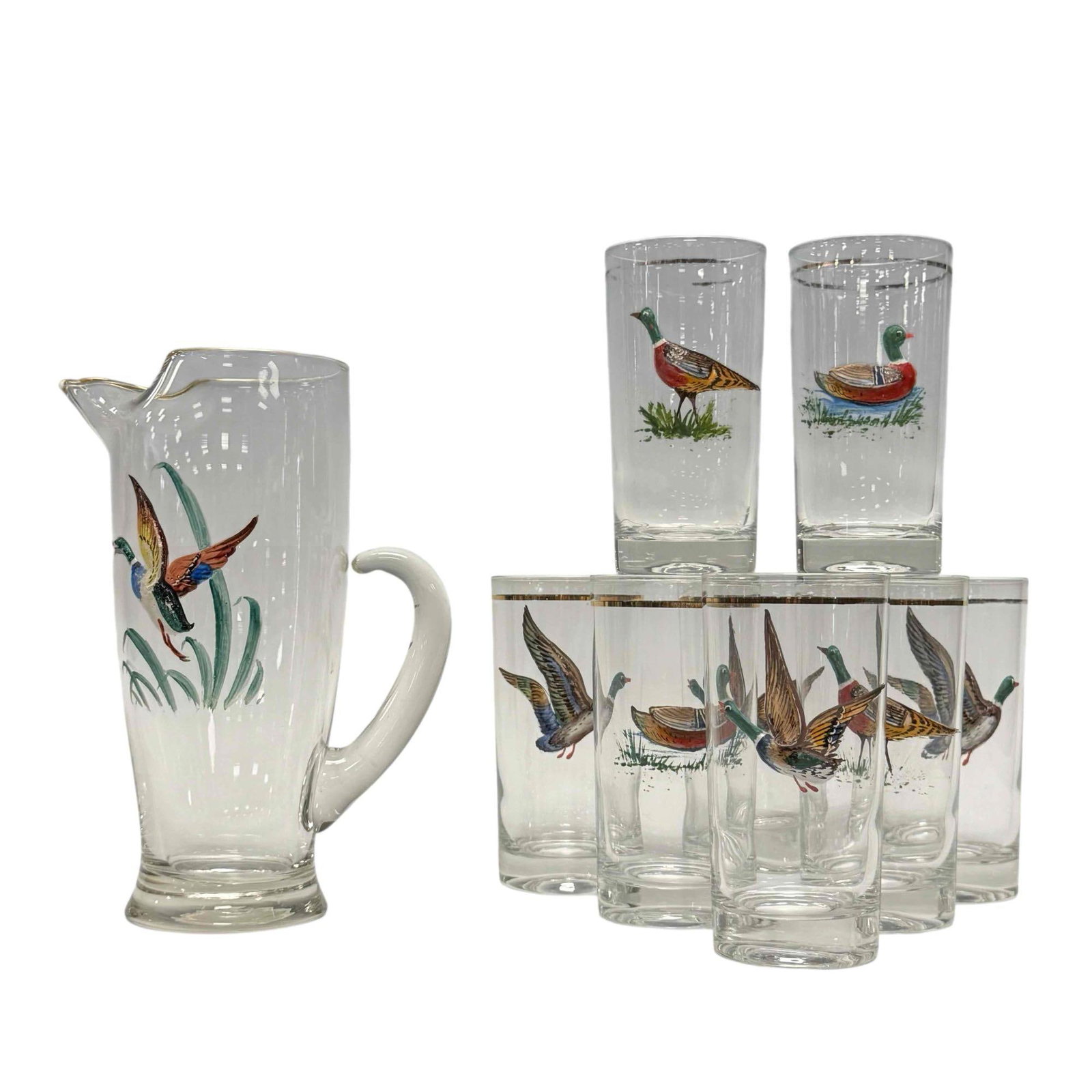 Ned Smith MCM Enameled Waterfowl Duck Highball Drink Set (9): 1960's Ned Smith Waterfowl highball barware drink set. Includes eight highball glass and pitcher with raised relief enameled mallard ducks design and gold trim. Measuring approx. 5.5" tall glasses wit