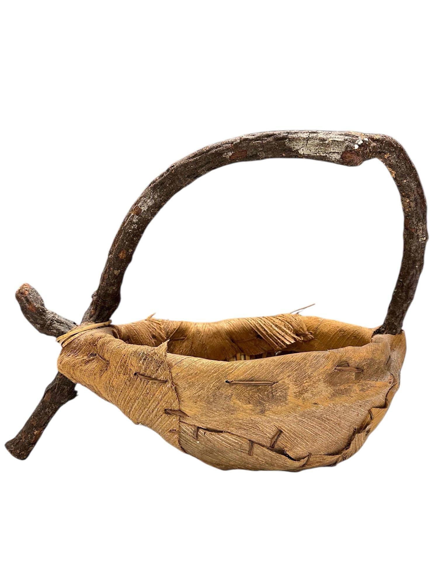 Primitive Native American Palm Bark Grapevine Basket: Primitive Folk Art hand woven twisted grapevine framed and woven palm bark basket. Measuring approx. 15" tall by 21" long by 12.5" wide. In good vintage condition, see photos.