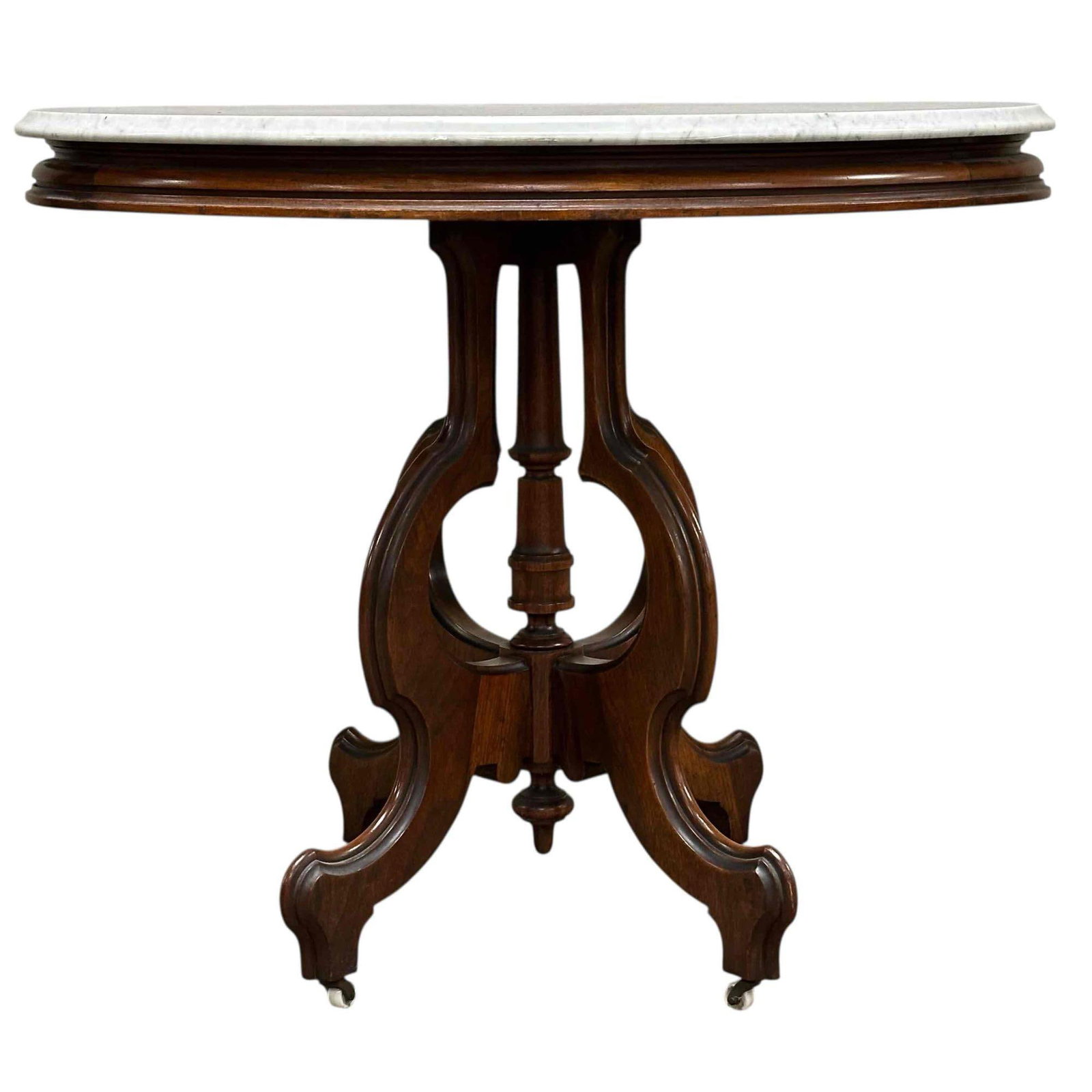 19th Century American Victorian Marble Top Table: American walnut base oval lamp table with white marble. measures approx. 29"H x 34.5"W x 25.5"D. Light use and wear consistent with age, as shown see photos.