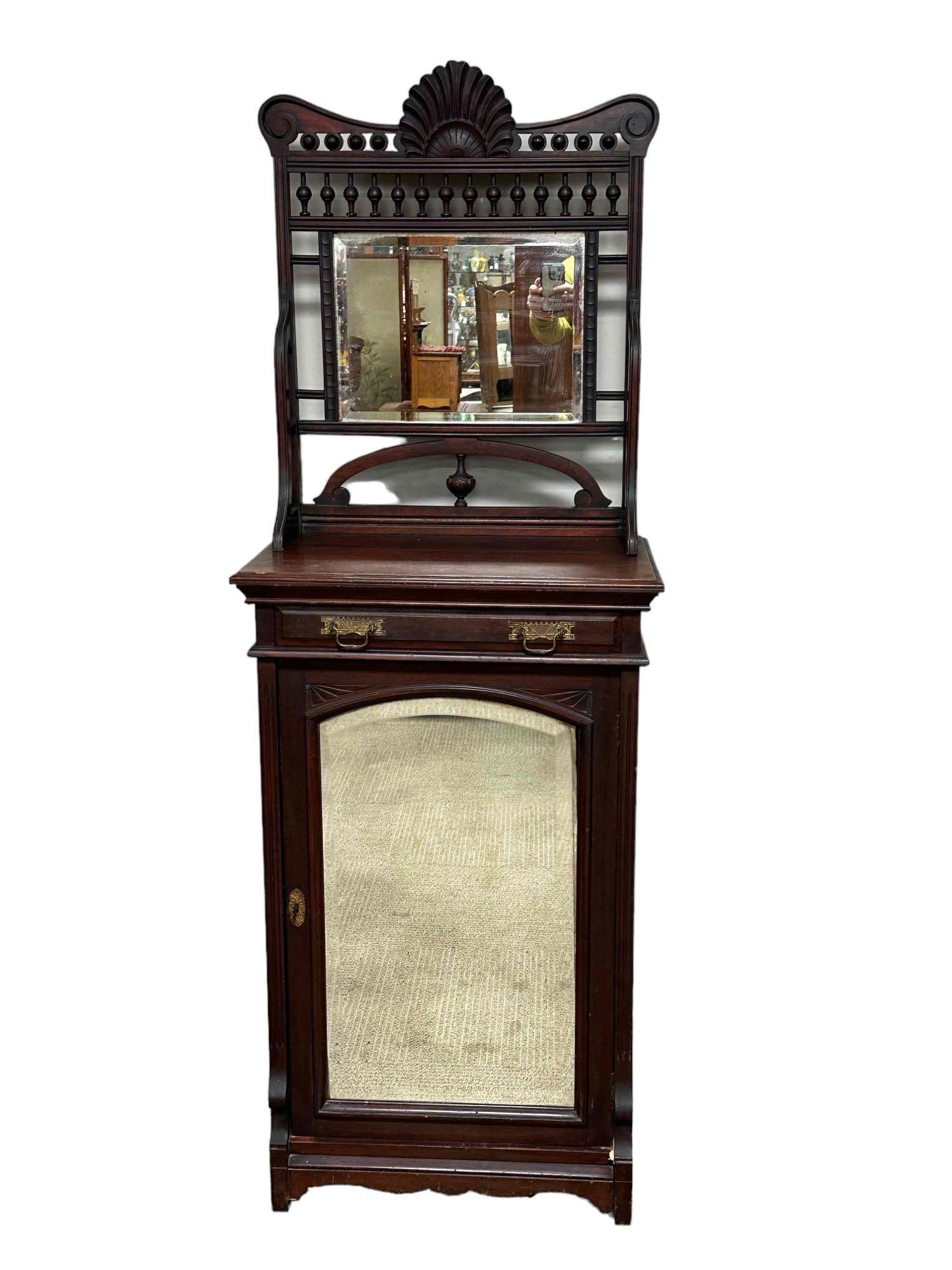 19th Century American Aesthetic Movement Mahogany Cabinet: A fine and elegant carved meet music or storage cabinet with mirror back top. 2pc and in good condition, light wear and scuffs as show, see photos. Measuring approximately 68” tall x 24” w