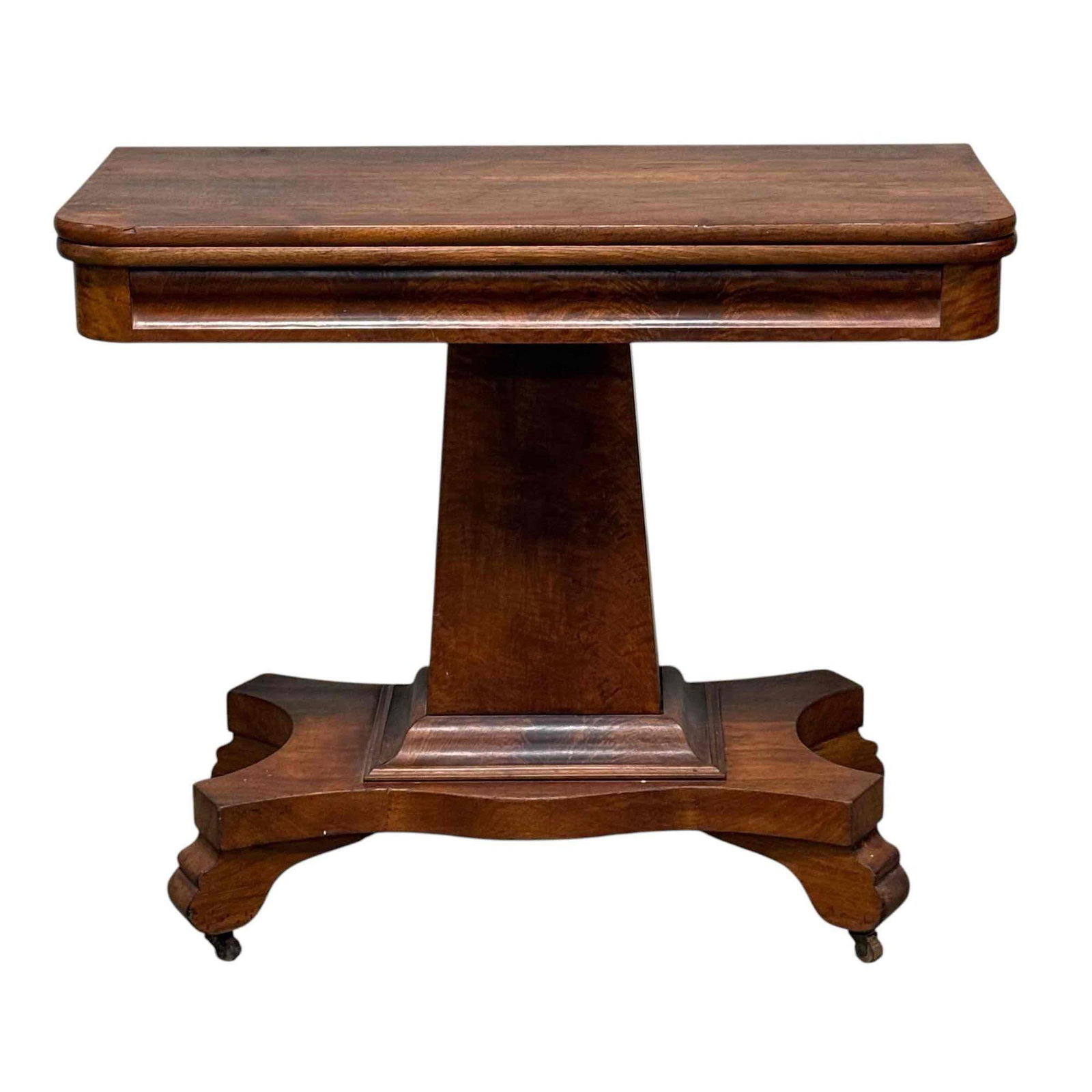 American Empire Mahogany Games Flip top Table: A squared columned base flip top game table seated on brass castors and measuring approx. 31" h x 36" w x 18" d. 36" x 36" top surface when open. Light use and wear, overall very good and sturdy mid 1