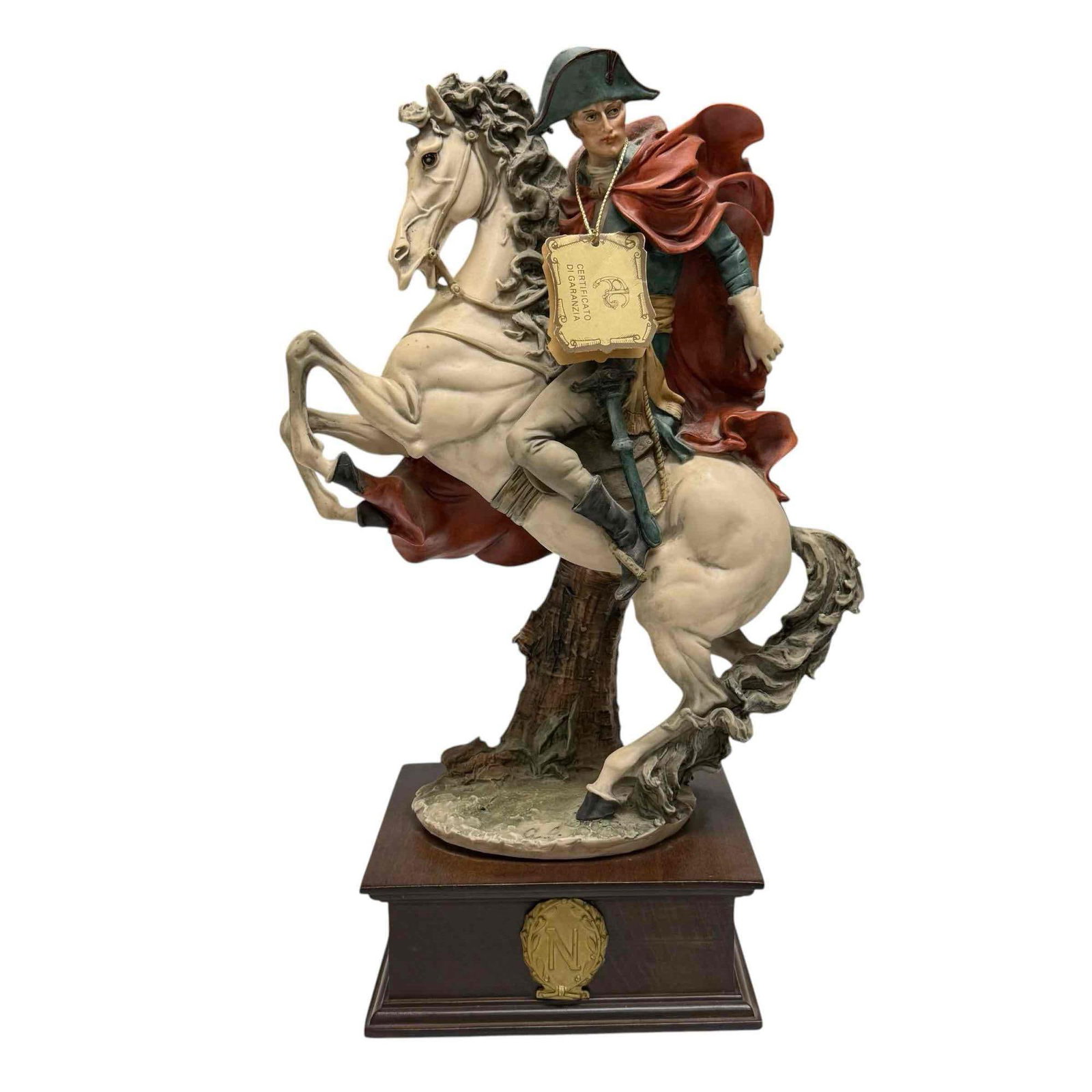 Giuseppe Armani Napoleon Bonaparte Horseback Sculpture: Giuseppe Armani figurine of Napoleon on squared wooden pedestal base. Depicting Napoleon Bonaparte in his famous pose of him crossing Alps on his horse, having original paper tag with artist number. M