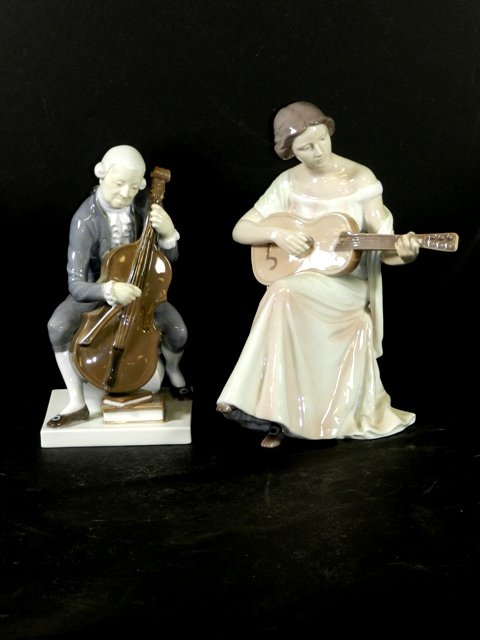 2 Royal Copenhagen B & G Musician Figurines: Including a lady with pink and white gown playing guitar # 1684 and a male playing the cello #2032. Both in good condition with no cracks or chips. See photos