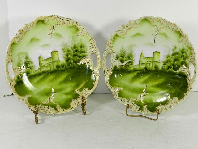 Pair RS Germany Castle Plates: Unmarked 11" RS Germany castle plates with main green base colors, hand painted and gold gilt trim. Minor surface wear.