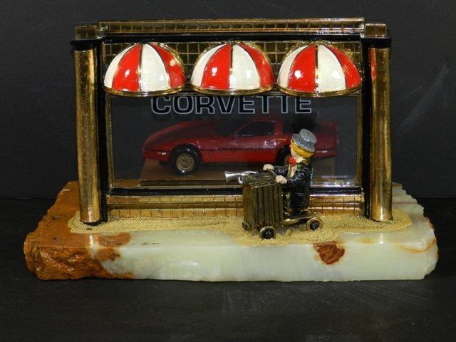 Signed Ron Lee Sculpture Corvette: Signed Ron Lee "Corvette" character on typical alabaster base, under plexi glass case and in good condition.