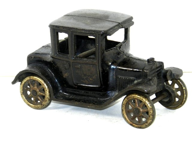 Arcade MFG Cast Iron Antique Car: Arcade MFG Cast Iron Antique Car approx 5" long signs of use and wear as shown. Overall fair condition, stamped interior as shown.