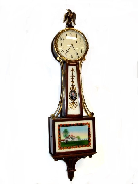 Waltham Banjo Clock Washington & Mt. Vernon: The mahogany case of typical form maintaining original Washington & Mt. Vernon eglomise painted tablets. Also with gilt decorated displayed eagle finial and presentation gold gilt pediment with suspen