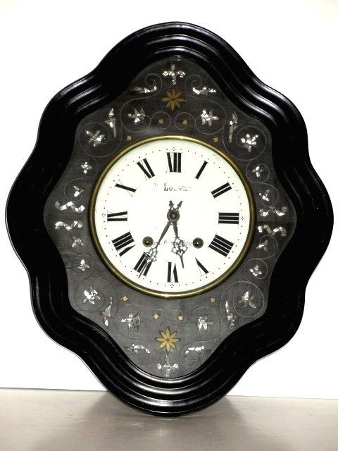 French Ebony Mother Of Pearl Wall Clock Ca.1870: French ebonized or black lacquer wall clock, c. 1870, and is marked on dial face. Having shaped front door with bronze and mother of pearl inlay. With original key and pendulum. This clock is from a o
