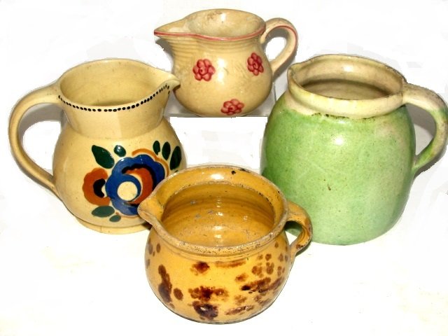 Hand Painted Decorated Pottery Bowls: One blue with border of white spots 4'' x 10'', one smaller in blue glazed 2 1/2'' x 7'', one yellow with flower decorations 2 1/2'' x 8''. Condition ware minor edge chips, tight hairline in yellow bo
