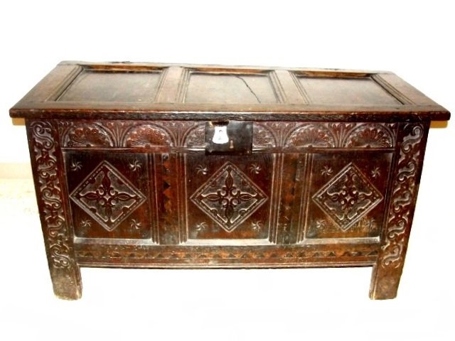 17TH C. Carved Oak Jacobean Coffer Ca. 1680: Or early 18th. C. This is a lovely old piece, with a good patina with an old Iron escutcheon, lunnette carved frieze above rectangular panels carved with lozenges raised upon channeled stile feet. Con