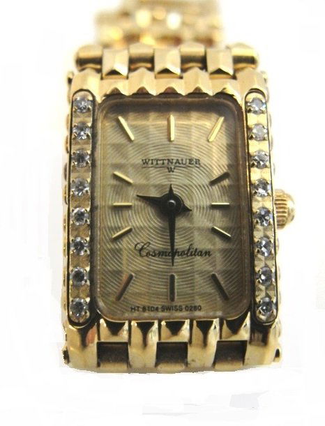 Wittnauer Diamond Gold Plated Lady's Watch: Wittenaur cosmopolitan gold plated stainless steel watch. The face has eight 0.01 round single cut diamonds per side, total of 0.16 carat. Band of variation of a panther link with faceted rectangles.
