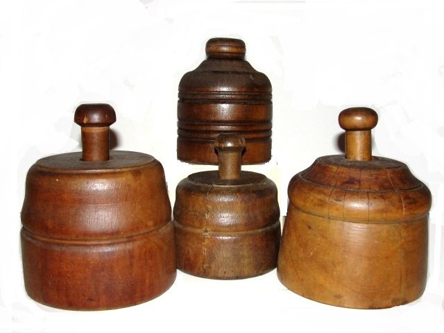 Four Turned Wooden Butter / Cookie Molds: Having various flower pattern. Condition very good normal wear and age cracks for age usage. Average 4 1/2'' tall. Color maybe a little brighter than actual color do to flash of camera.