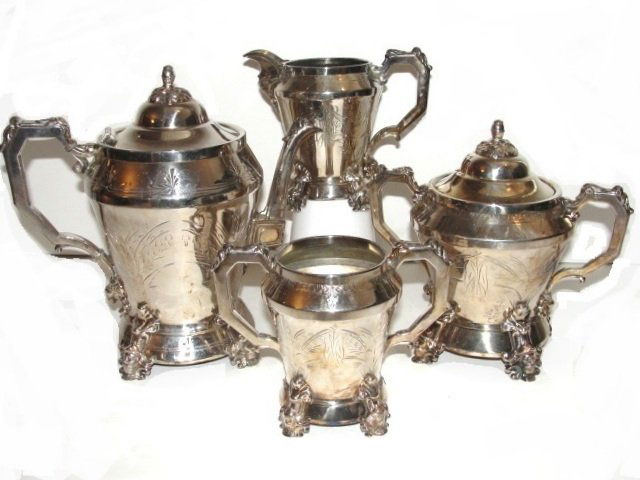 Victorian E.G. Webster Ornate Silver Plate Tea Set: Having heads on feet, rams head below handles, inscribed foliage designs on body and shaped handle. Condition very good. Tea Pot, H. 9 1/2'' W. 10'', lidded master sugar bowl 7 1/2'' x 7 1/2'', master