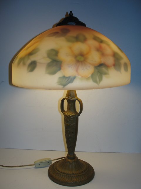 Pittsburg Reverse Painted Lamp: Reverse painted shade with yellow flowers on soft white background, with fancy painted cream color base stamped PBL.CO. Condition minor chip on edge of top, base with minor paint chip. H. 23'' shade 8