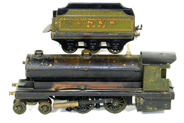 Bowman Live Steam LNER 4472 Loco and Tender: Bowman Live Steam LNER 4472 Loco and Tender. Engine measures 12" long. Tender is 7" long. Considerable wear all around with a repair on the bottom. Probably a better display pair than functional. Good