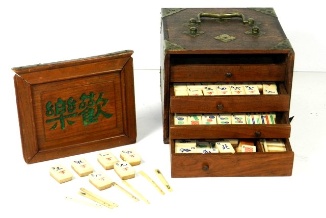 1800's Chinese Mah-Jongg Boxed Game: Hand crafted Chinese ivory and bamboo mahjong set with brass accented teakwood box. Set includes ivory numbered sticks, and game pieces in a fitted wooden box with 4 drawers. Each mahjong piece is han