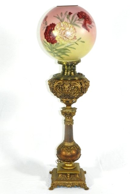 B&H Tall Ornate Victorian Banquet Lamp: Bradley & Hubbard tall ornate Victorian banquet lamp with floral painted ball shade. Reticulated copper ball and column with raised relief and gilded metal. B&H stamped on oil cap. Used to be an oil l