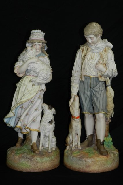 Signed L.Binet Bisque Figurines by F. Bing: Figurines with sheep & dogs. Measures approx. 24"h x 9"w. Condition: Male has damage near face as showing .